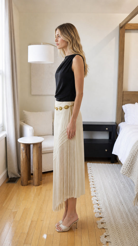Side profile of woman in beige fringe long skirt