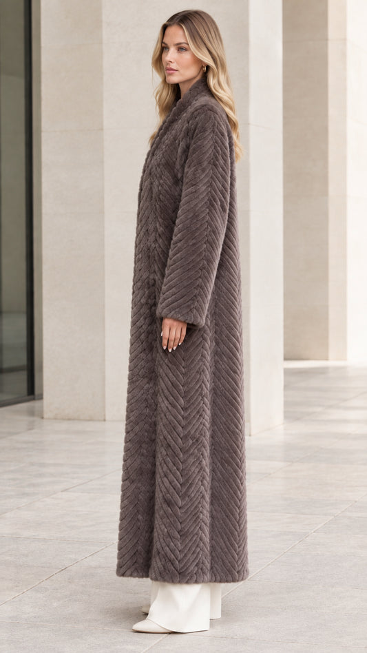 Side profile of model wearing longline charcoal grey faux fur overcoat