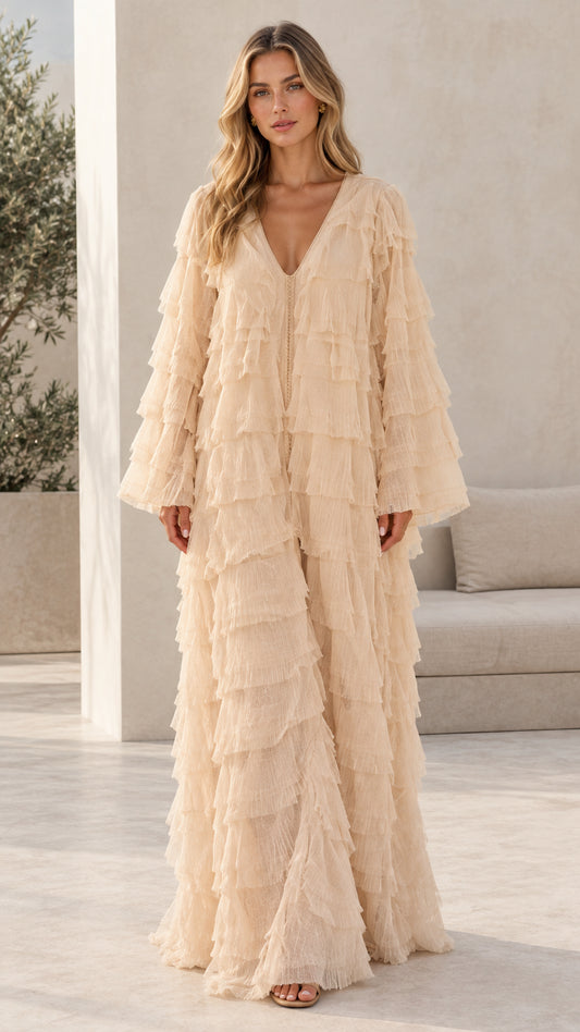 Model wearing champagne tiered fringe long sleeve maxi dress front view
